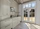 Custom wet bar with cabinetry, sink, and access to the backyard at 413 Eastover Rd, Charlotte, NC 28207