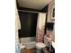 Bathroom with dark tile and floral shower curtain at 4718 Americana Ave, Charlotte, NC 28215