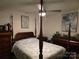 Bedroom with a wooden canopy bed and two matching dressers at 4718 Americana Ave, Charlotte, NC 28215