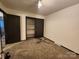 Bedroom with ceiling fan and ample closet space at 4718 Americana Ave, Charlotte, NC 28215