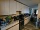 Kitchen with white cabinets, granite countertops, and stainless steel appliances at 4718 Americana Ave, Charlotte, NC 28215