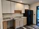 Kitchen with wood cabinets, granite counters, and black appliances at 4718 Americana Ave, Charlotte, NC 28215