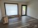 Spacious living room with large window and new flooring at 4718 Americana Ave, Charlotte, NC 28215