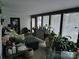 Bright living room with large windows, comfortable seating, and lots of plants at 4718 Americana Ave, Charlotte, NC 28215