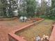 Brick patio with seating area, surrounded by landscaping at 4718 Americana Ave, Charlotte, NC 28215
