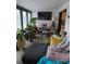 Sunroom with ample natural light, comfy seating, and lots of plants at 4718 Americana Ave, Charlotte, NC 28215