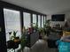 Sunroom featuring large windows and a stylish mid-century modern cabinet at 4718 Americana Ave, Charlotte, NC 28215