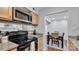 Eat-in kitchen with view into dining area and stainless steel appliances at 5020 Sardis Rd # I, Charlotte, NC 28270