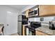 Updated kitchen featuring stainless steel appliances and wood cabinets at 5020 Sardis Rd, Charlotte, NC 28270