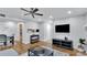 Spacious living room with hardwood floors and a large TV at 5020 Sardis Rd # I, Charlotte, NC 28270