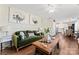 Spacious living room with a green velvet sofa and wooden coffee table at 506 S 11Th St, Bessemer City, NC 28016