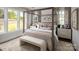 Main bedroom with canopy bed, neutral decor, and plenty of natural light at 5213 Mint Harbor Way # 0351, Charlotte, NC 28269