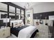 Stylish bedroom with black and white decor and guitars on the wall at 5213 Mint Harbor Way # 0351, Charlotte, NC 28269