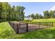 Community dog park with fenced area and new wood chips at 5213 Mint Harbor Way # 0351, Charlotte, NC 28269