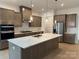 Modern kitchen with large island, pendant lighting, stainless steel appliances, and custom cabinets at 5213 Mint Harbor Way # 0351, Charlotte, NC 28269
