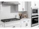 Modern kitchen features gas cooktop, white cabinets, and white subway tile backsplash at 5213 Mint Harbor Way # 0351, Charlotte, NC 28269