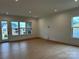 Spacious living room with hardwood floors, recessed lighting, and large windows for natural light at 5213 Mint Harbor Way # 0351, Charlotte, NC 28269