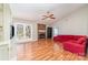 Spacious living room with hardwood floors, brick fireplace, french doors, and lots of natural light at 6000 Carmel Station Ave, Charlotte, NC 28226