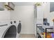 Convenient laundry room with washer, dryer, storage shelves, and tile flooring at 6500 Clavell Ln # B, Charlotte, NC 28210