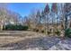Secluded backyard featuring a grassy lawn and lush trees providing a serene outdoor space at 724 Mercer Pl, Huntersville, NC 28078