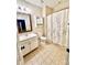 Cozy bathroom featuring a vanity with framed mirror, storage cabinet and a shower with stylish curtain at 724 Mercer Pl, Huntersville, NC 28078