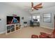 Inviting bedroom featuring a fan, TV, workspace, and a cozy leather chair for relaxing and entertainment at 724 Mercer Pl, Huntersville, NC 28078