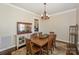 Formal dining room featuring a rustic wooden table and chandelier at 724 Mercer Pl, Huntersville, NC 28078