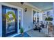 Front porch with black door, wreath, and two rocking chairs at 724 Mercer Pl, Huntersville, NC 28078