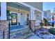 Inviting front porch with stone pillars and a blue ceiling at 724 Mercer Pl, Huntersville, NC 28078
