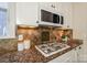 Modern kitchen features granite countertops and gas cooktop at 724 Mercer Pl, Huntersville, NC 28078