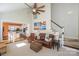 Open-concept living room featuring soaring ceilings, staircase, and seamless flow into the adjacent eat-in kitchen at 724 Mercer Pl, Huntersville, NC 28078