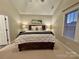 Serene main bedroom featuring a comfortable bed, bedside lamps, and a window offering natural light at 724 Mercer Pl, Huntersville, NC 28078