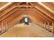Spacious attic featuring exposed wooden beams and flooring, with a small window at 7545 Haley Ln, Indian Land, SC 29707