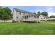 Rear exterior view of a home with a covered porch, stairs, and well-maintained lawn at 7545 Haley Ln, Indian Land, SC 29707