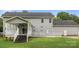 Rear exterior view of a home with a covered porch, stairs, and well-maintained lawn at 7545 Haley Ln, Indian Land, SC 29707