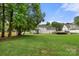 Expansive backyard featuring lush lawn, mature trees, and a partial view of the home's rear elevation at 7545 Haley Ln, Indian Land, SC 29707