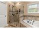 The bathroom features a glass enclosed shower, tub, and neutral tile at 7545 Haley Ln, Indian Land, SC 29707