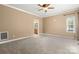 This bedroom has neutral walls, carpet, a ceiling fan, and an ensuite bathroom at 7545 Haley Ln, Indian Land, SC 29707