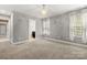 This bedroom features light gray walls, white trim, and carpet floors at 7545 Haley Ln, Indian Land, SC 29707