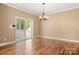 Versatile dining space with hardwood flooring, modern lighting, and sliding door to the back yard at 7545 Haley Ln, Indian Land, SC 29707