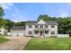 Charming two-story home features a welcoming front porch, three-car garage, and beautifully manicured lawn at 7545 Haley Ln, Indian Land, SC 29707