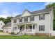 Traditional home featuring a welcoming porch, well-maintained landscaping, and an attached three-car garage at 7545 Haley Ln, Indian Land, SC 29707