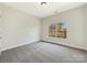 Bright bedroom with grey carpet and large window at 9153 Leah Meadow Ln, Charlotte, NC 28227