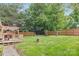 Large, fenced backyard featuring a deck with pergola and a fire pit at 10912 Treebark Dr, Charlotte, NC 28226