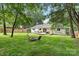 Backyard featuring a pergola, deck, fire pit, and lush greenery at 10912 Treebark Dr, Charlotte, NC 28226