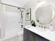 Charming bathroom features a navy vanity with gold hardware and a tub/shower with black fixtures at 10912 Treebark Dr, Charlotte, NC 28226