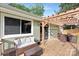 Wooden deck featuring a sofa, a dining set, and a pergola at 10912 Treebark Dr, Charlotte, NC 28226