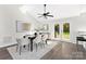 Bright dining area with French doors leading to the backyard, featuring a modern table and stylish decor at 10912 Treebark Dr, Charlotte, NC 28226