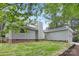 Home's exterior features green siding, brick foundation, and a manicured lawn at 10912 Treebark Dr, Charlotte, NC 28226