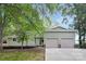 Charming home with a two-car garage, well-maintained lawn and an inviting front entrance at 10912 Treebark Dr, Charlotte, NC 28226